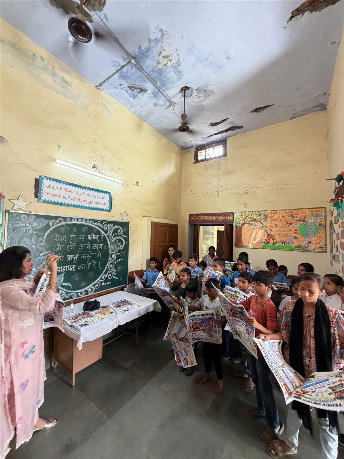A classroom full of children at a government school in Meerut holding up their new Teddy News issues