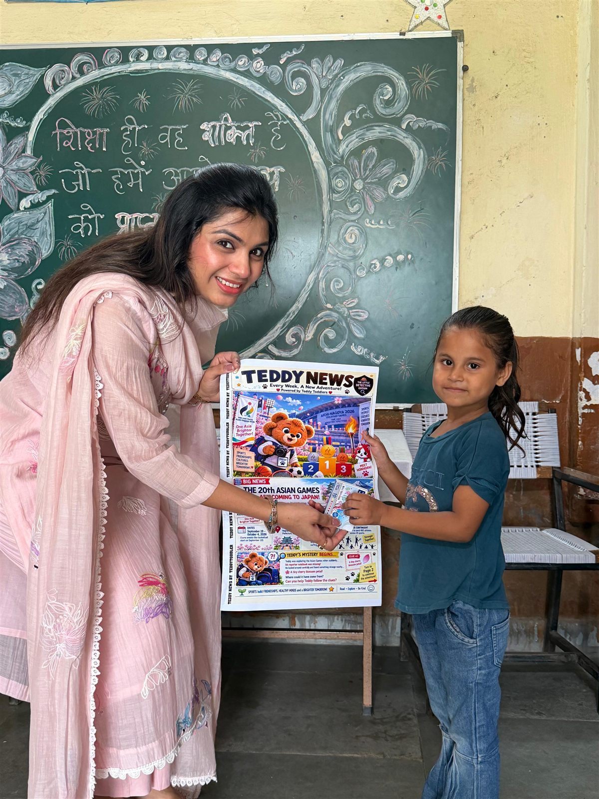 A young student smiling while receiving her Teddy News issue