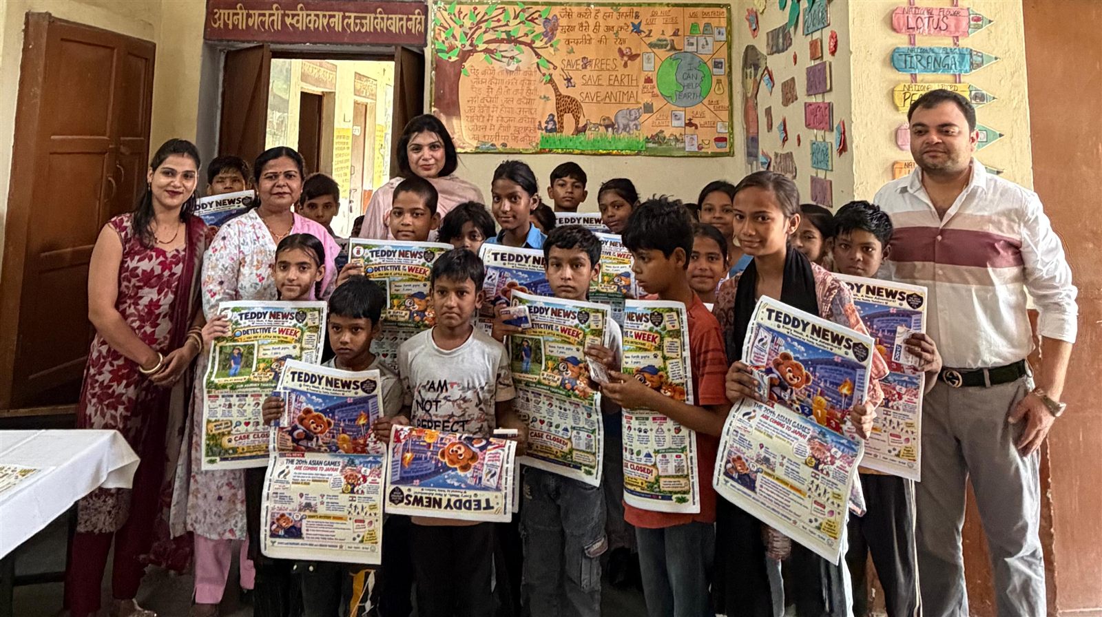 A group of students with the Teddy News team, holding up their new issues